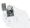 Zapalniczka Zippo z przodu, szczotkowany chrom Otwarta i zapalona z wizerunkiem Erica Claptona i Rona Pownalla w stylizowanej dłoni